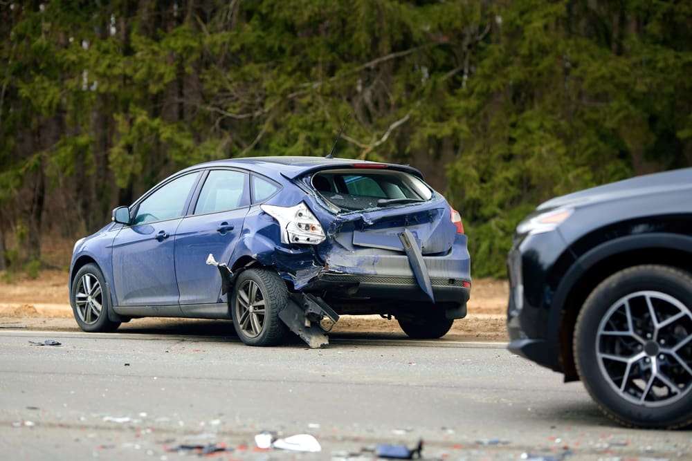 Vehicle with severe rear-end damage after being struck in a rear-end car accident.